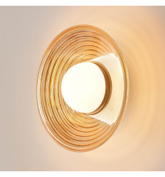 Round design LED wall light in amber glass with white...